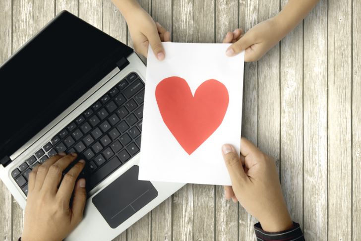 laptop and a heart signifying relationship between brand and micro influencer