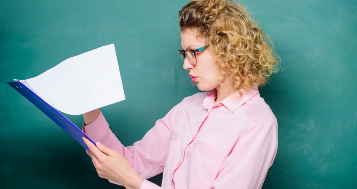 woman engrossed by feature article on clipboard